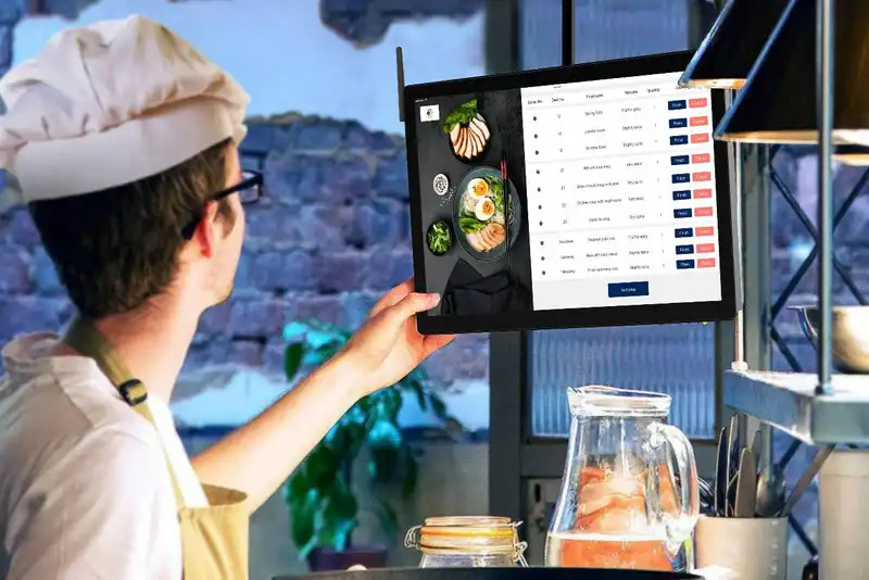 Zandoe delivery driver picking up a verified restaurant order for handoff